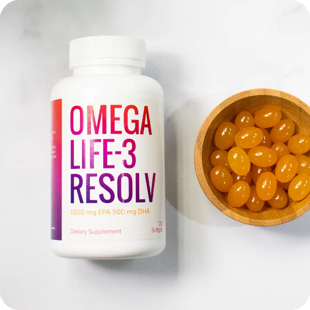 Bottle of OmegaLife-3 Resolv next to bowl of softgels