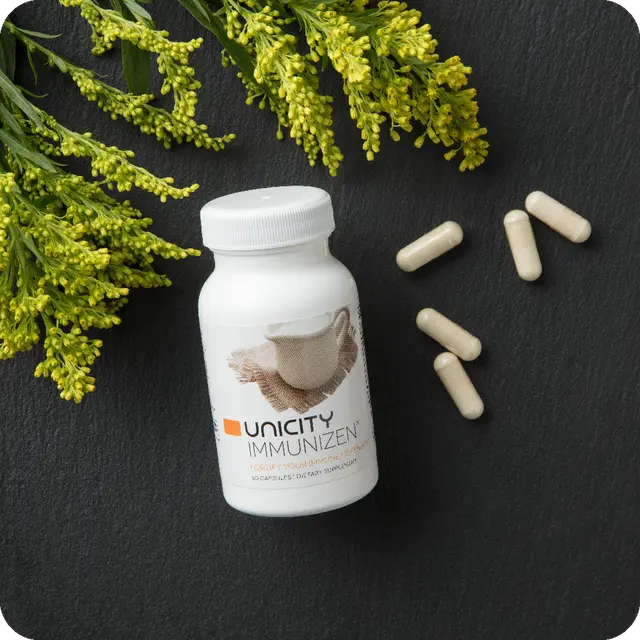 Bottle of Immunizen next to capsules