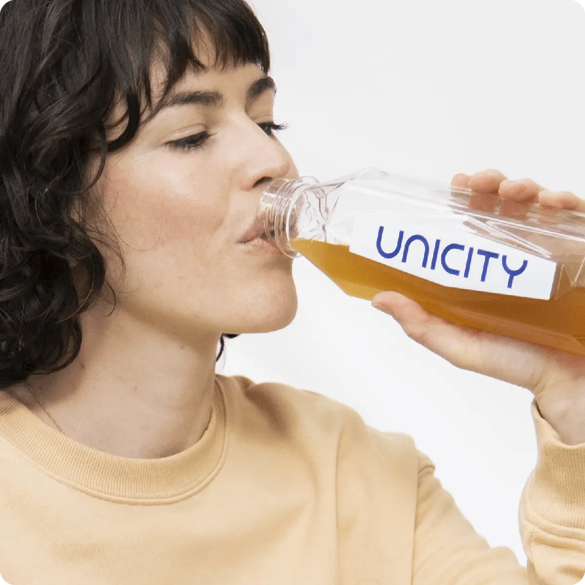 Girl drinking Unicity's Unimate