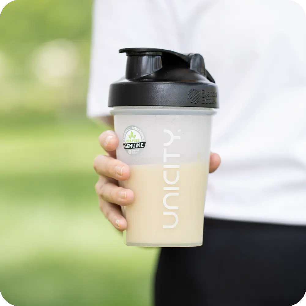 Hand holding the Unicity BlenderBottle®