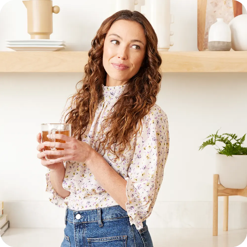 Mujer sosteniendo un vaso de Unimate