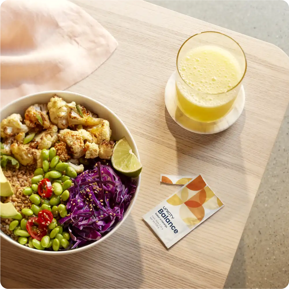 Holding glass of Balance next to food