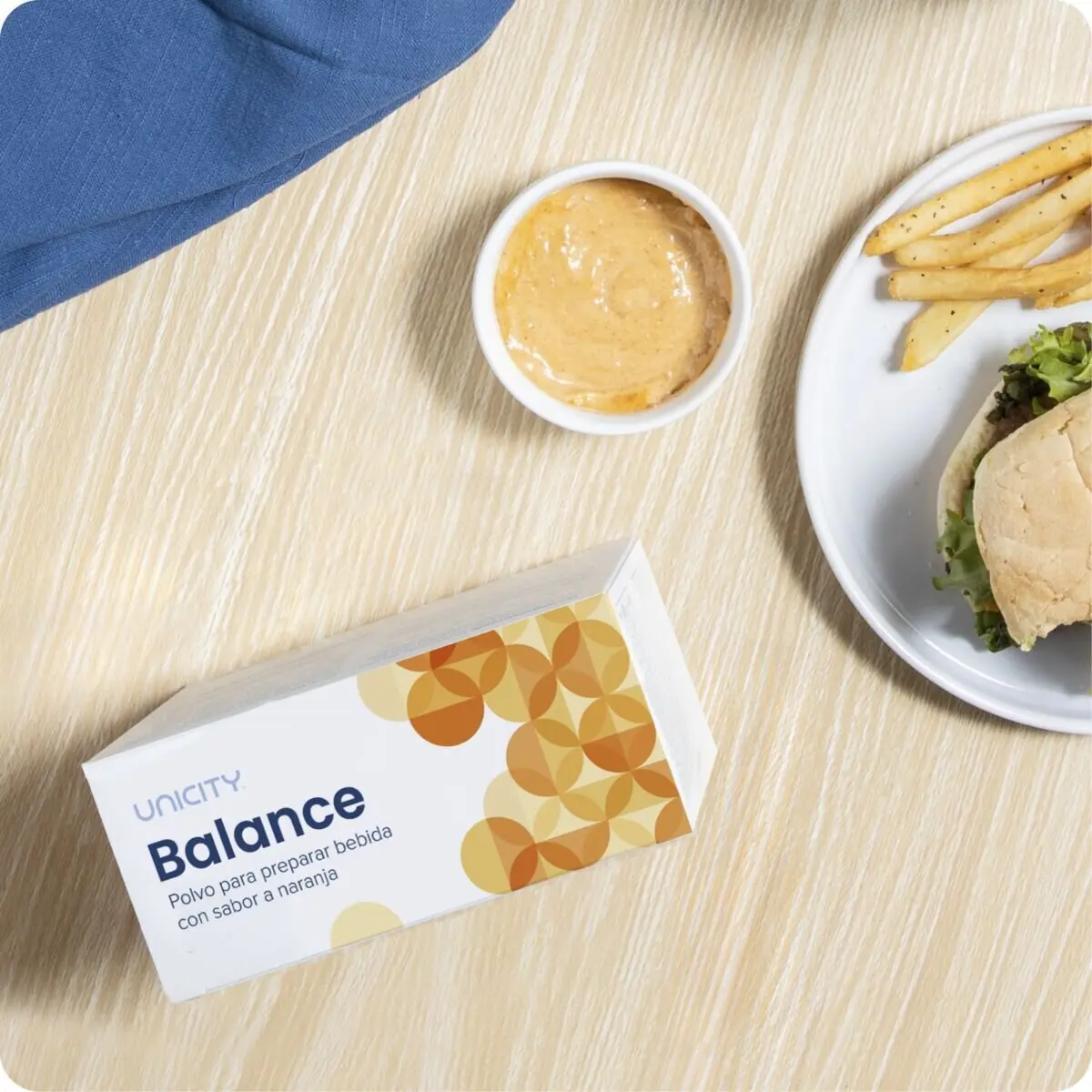 Box of Unicity Balance next to plate of food