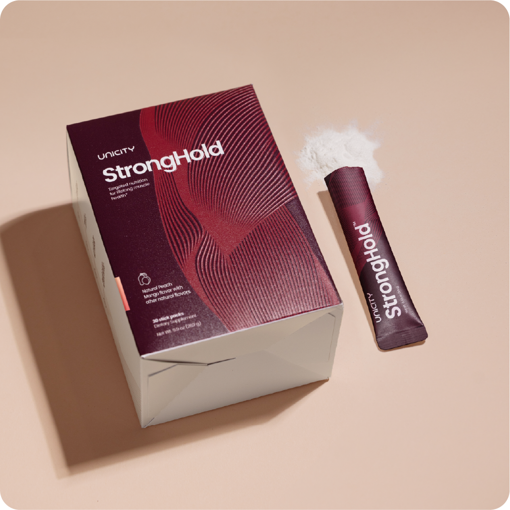 Box of STRONGHOLD by Unicity next to stick packs