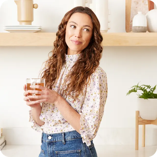 Woman holding cup of Unimate