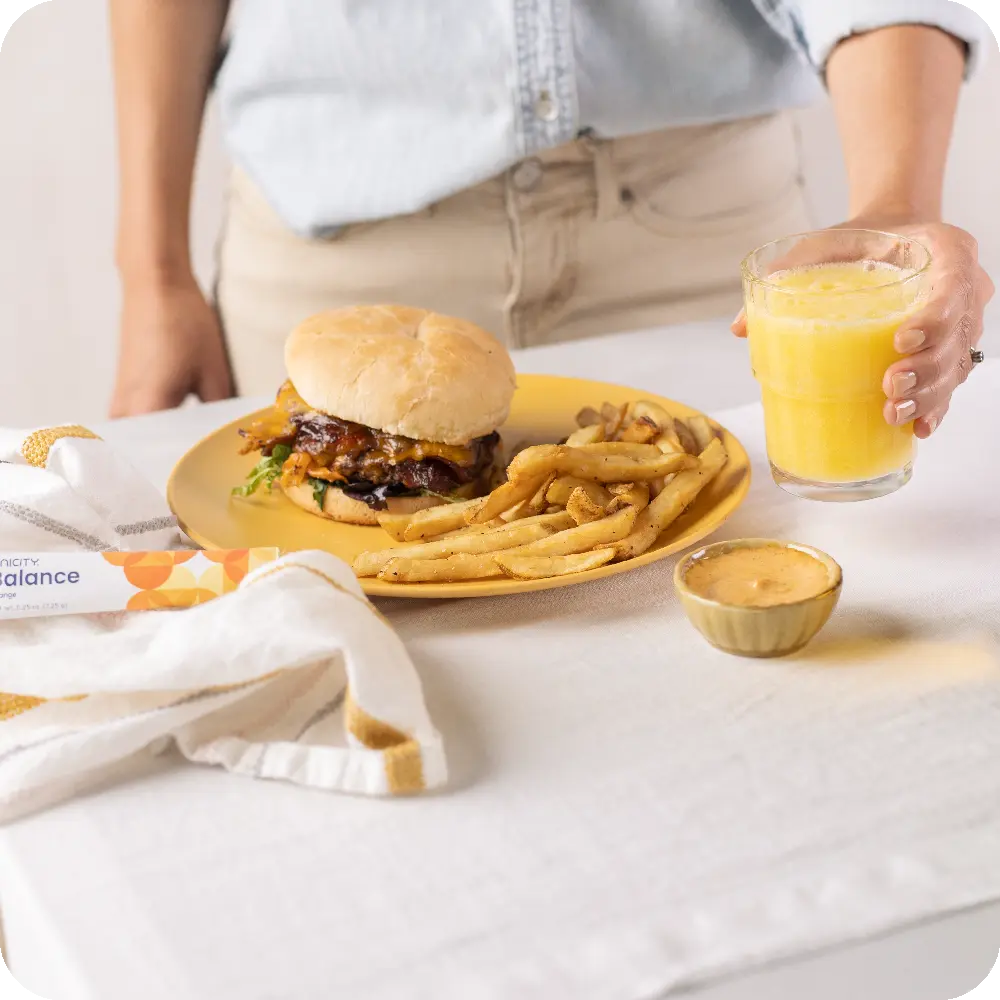 Holding glass of Balance next to food